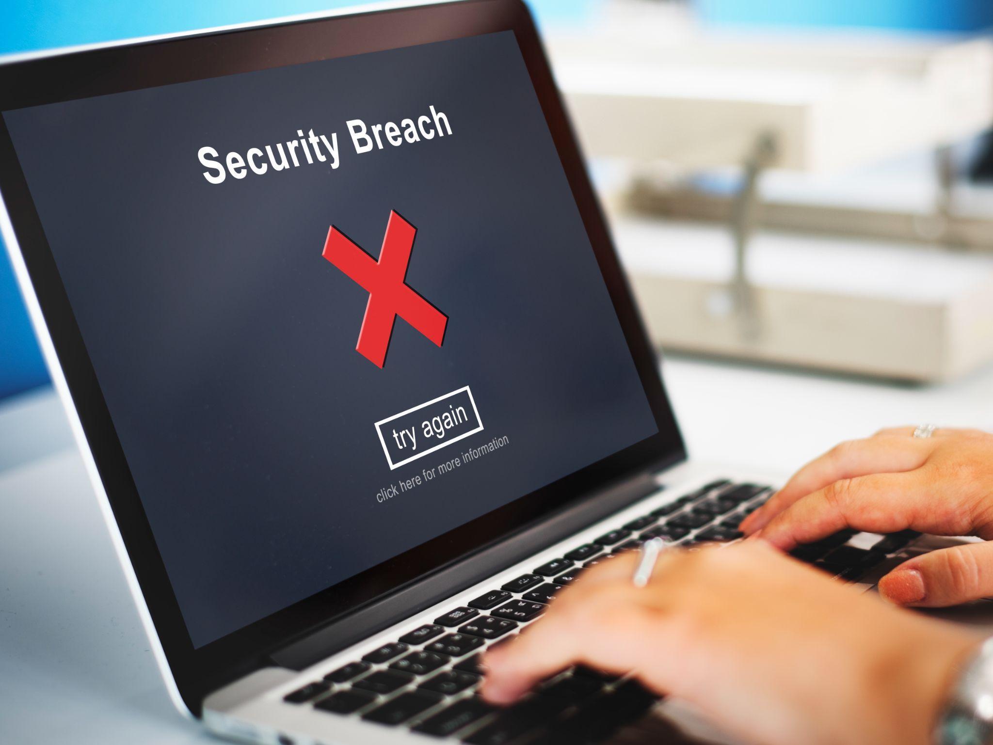 Laptop displaying security breach warning, representing risks of confidentiality failures and need for secure data handling in whistleblower investigations